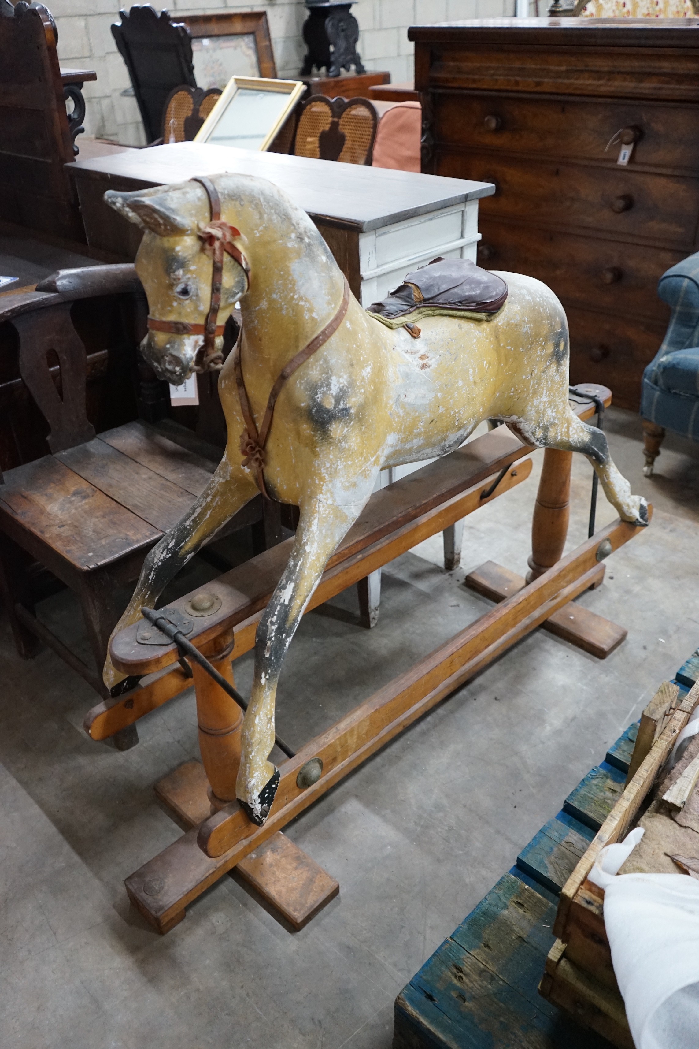 A vintage Tri-Ang rocking horse on pine safety frame, length 132cm, height 112cm